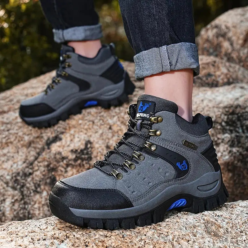 Rugged gray hiking boots with blue accents and black soles.