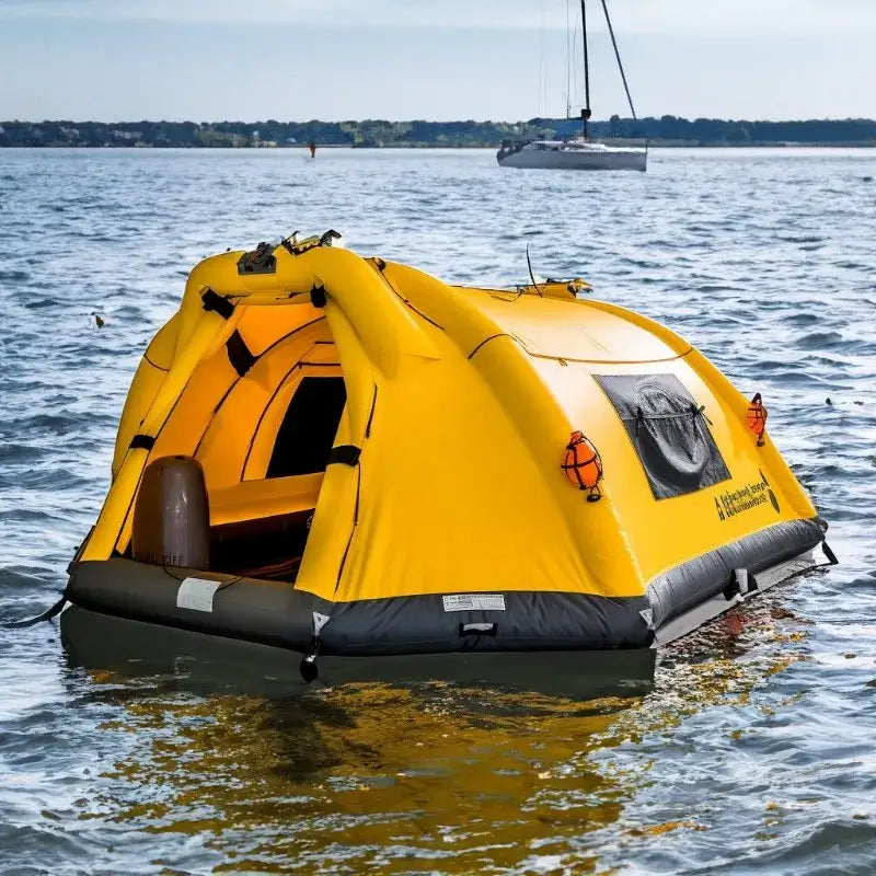 Yellow inflatable life raft floating on water.