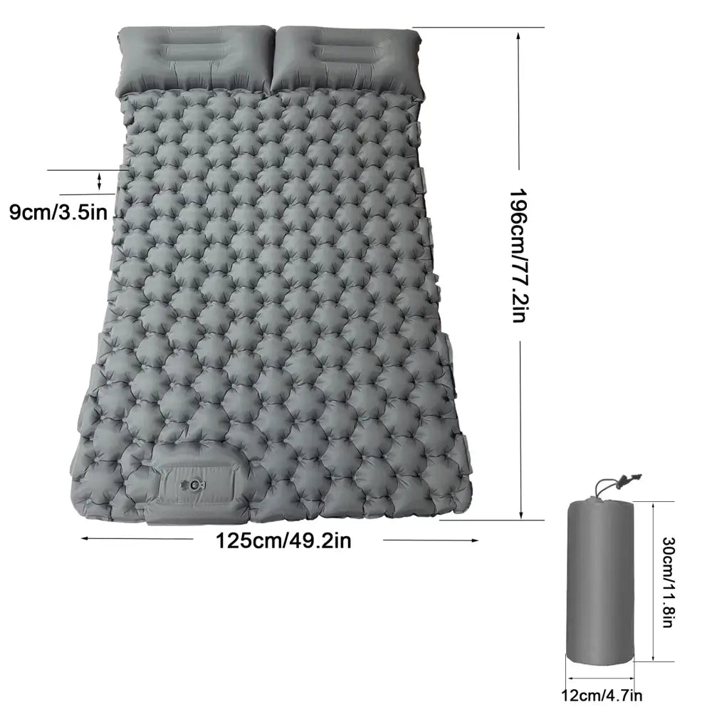 Inflatable camping sleeping pad with attached pillows and a textured, bubble-like surface.