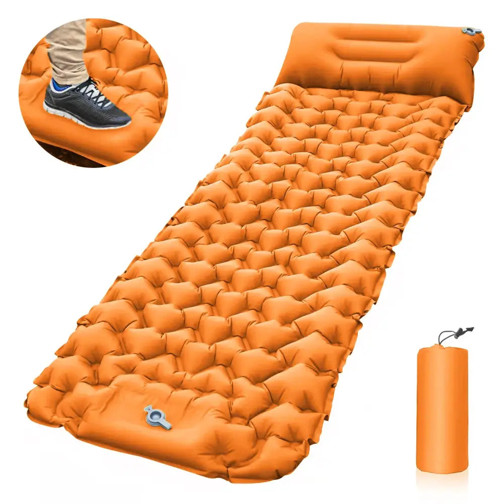 Inflatable orange camping sleeping pad with a textured surface and attached pillow.