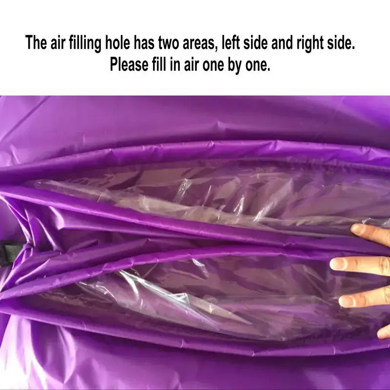 Partially inflated purple air mattress or inflatable bed with a hand visible.