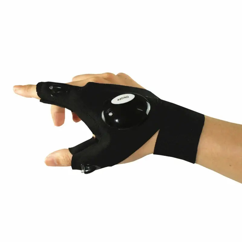 Fingerless glove with built-in LED light worn on a hand.