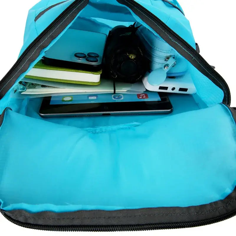 Bright turquoise backpack partially unzipped to reveal electronic devices and school supplies inside.