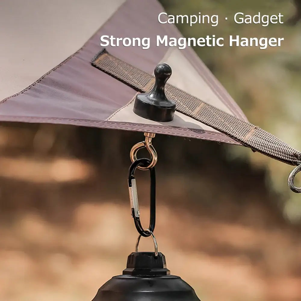 Strong magnetic hanger attached to a tent with a carabiner and lantern hanging from it.