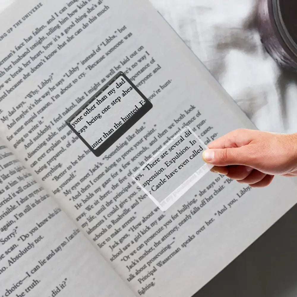 Book or document page with text and a highlighted section being pointed to by a finger.