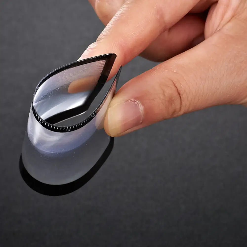 Teardrop-shaped computer mouse or trackpad device held between fingers.