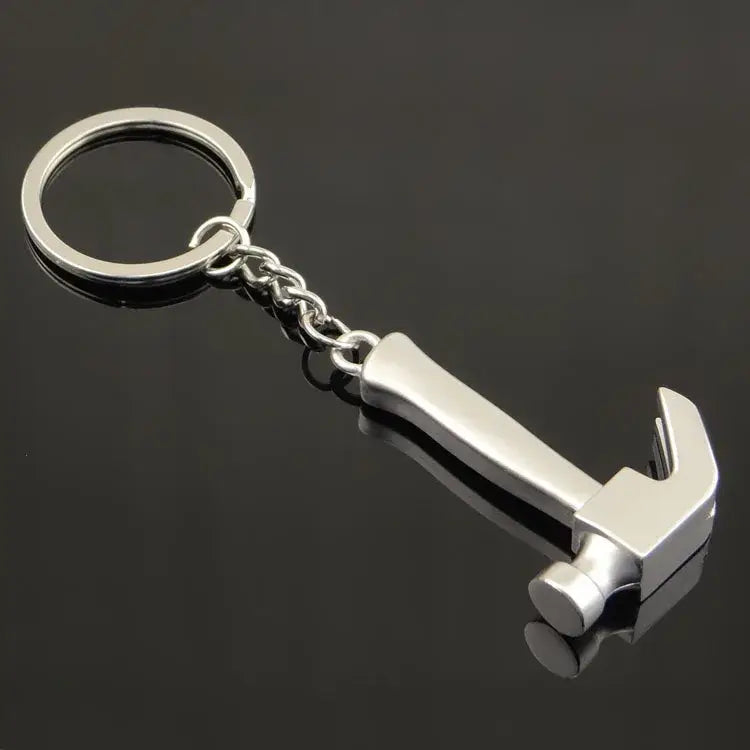 Hammer-shaped keychain with a metal ring and chain attachment.