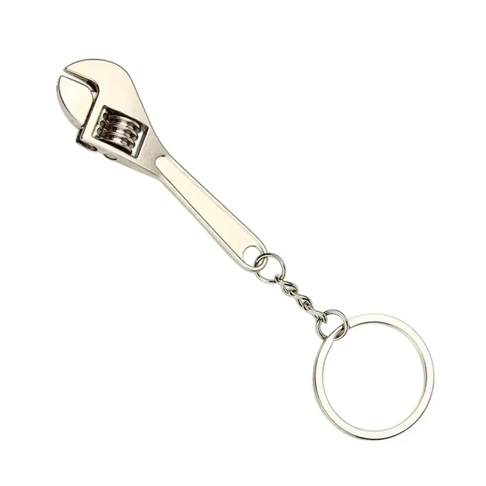 Adjustable wrench keychain with a metal ring attached.