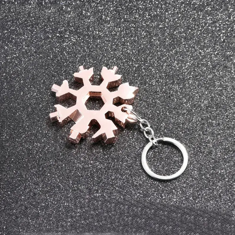 Snowflake-shaped keychain made of light-colored material.