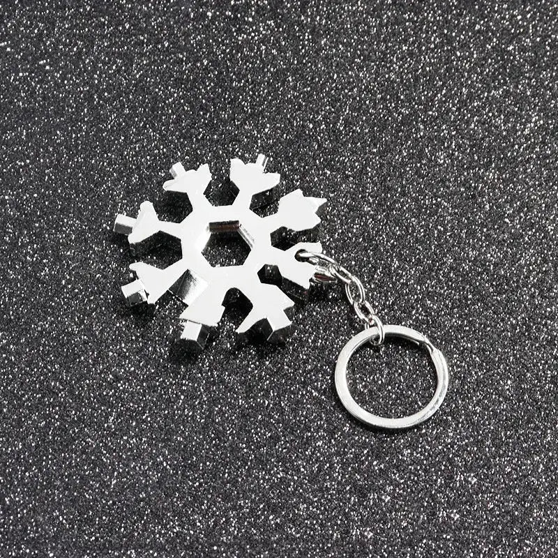 Snowflake-shaped keychain or pendant with a metallic ring attached.