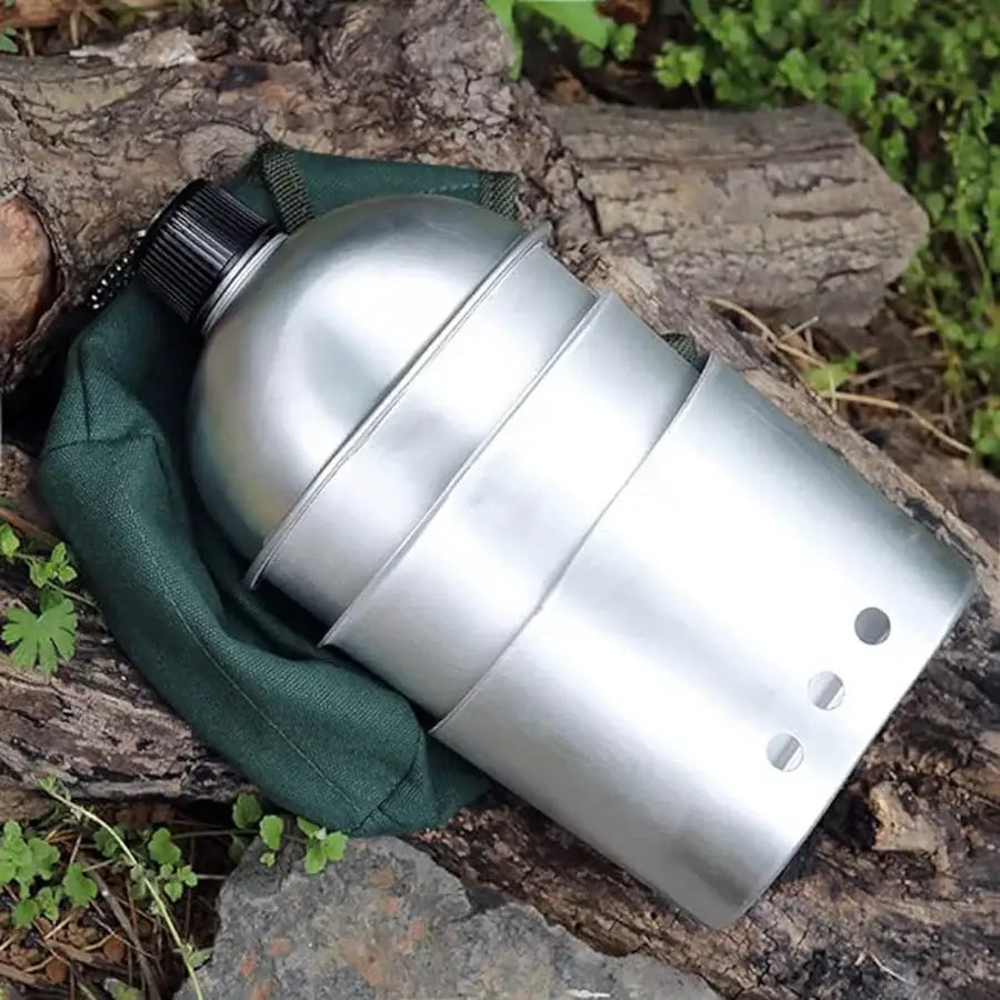 Metallic canteen or water bottle with ribbed design partially wrapped in green fabric.