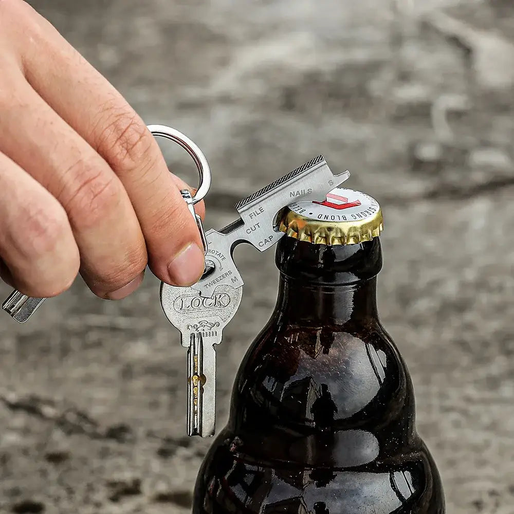 Bottle opener key ring being used to open a beer bottle.