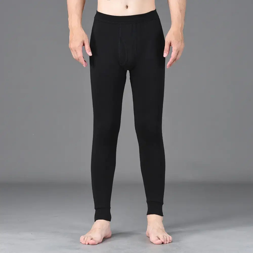 Black fitted leggings or thermal underwear worn on a person’s lower body.