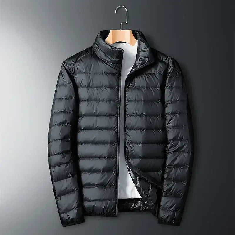 Black quilted puffer jacket hanging on a wooden hanger.