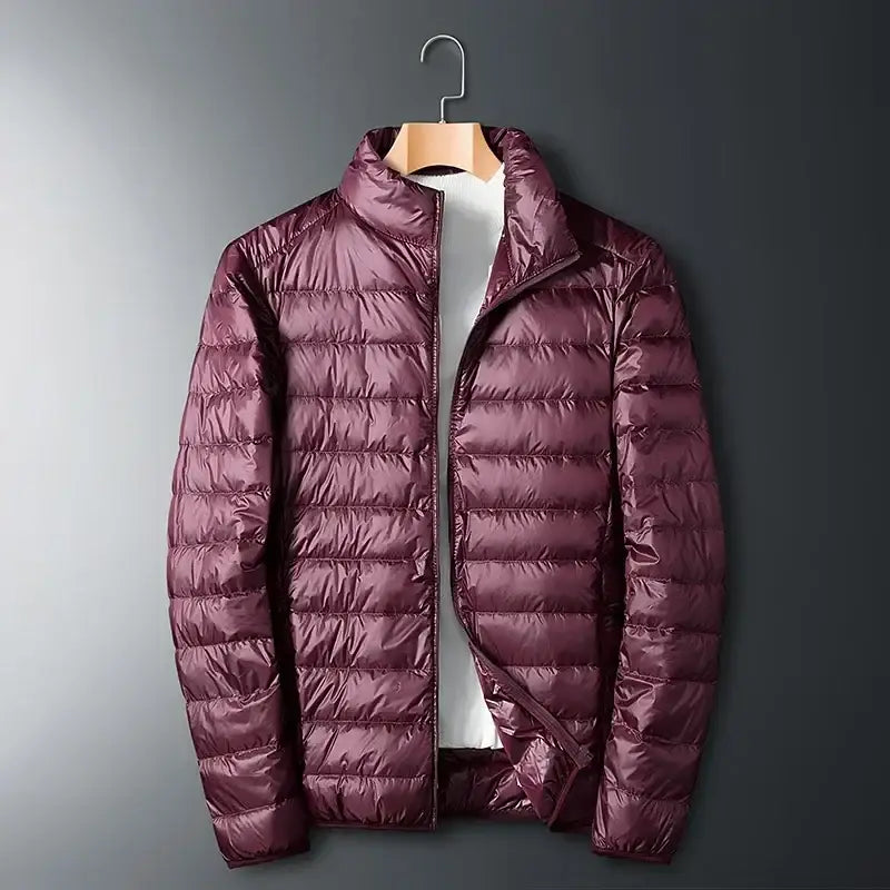 Burgundy puffer jacket hanging on a wooden hanger.