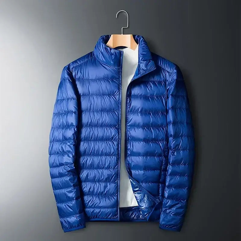 Blue puffy down jacket hanging on a wooden hanger.