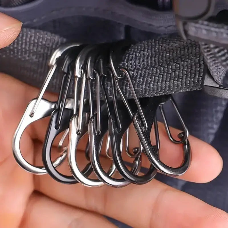 Set of metal carabiners or climbing hooks attached to a strap.