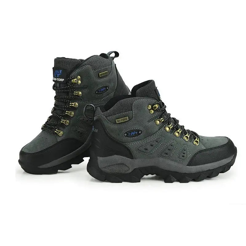 Pair of rugged hiking boots with gray and black coloring and neon yellow laces.