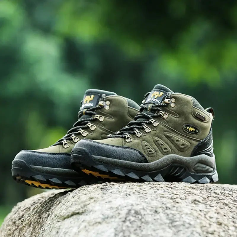 Pair of rugged hiking boots sitting on a rock.