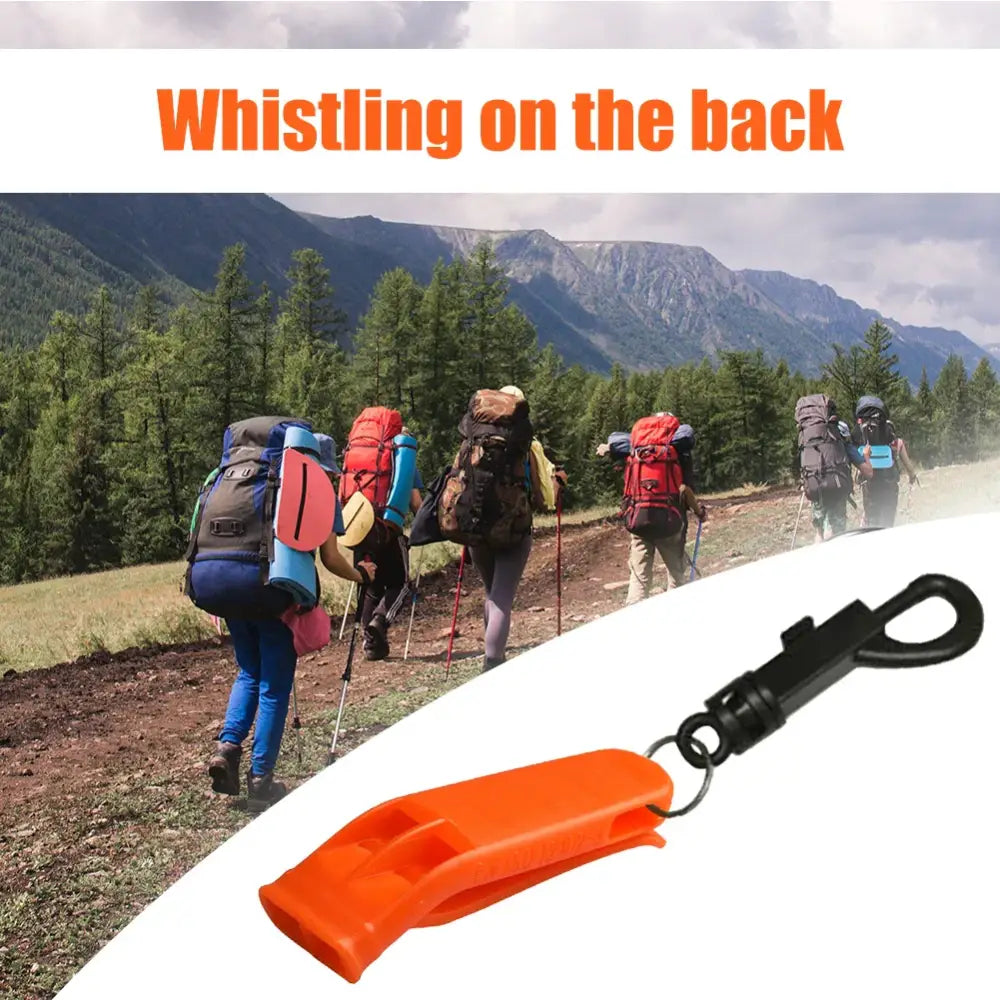 Orange plastic whistle with a black clip attachment.