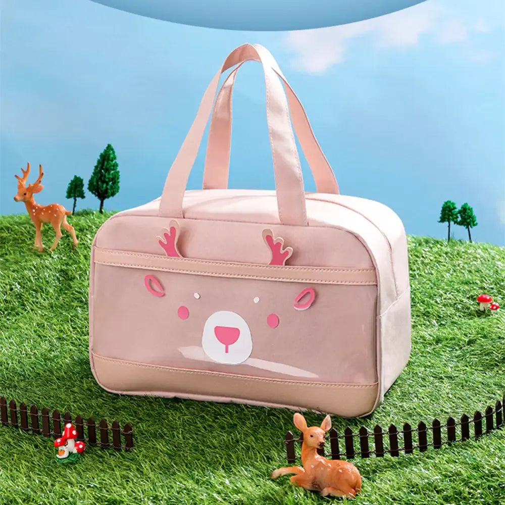 Pink children’s bag with a cute bear face design on the front.