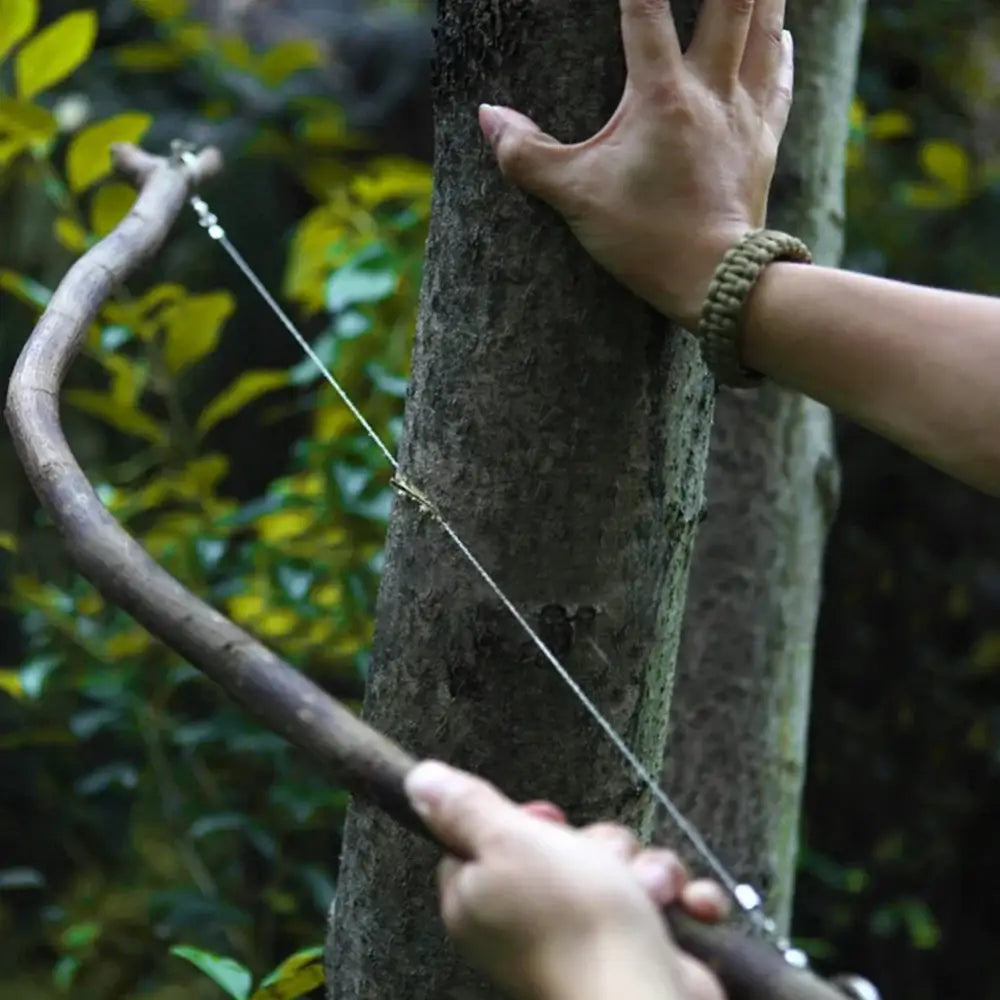 Bow and arrow being drawn against a tree trunk.