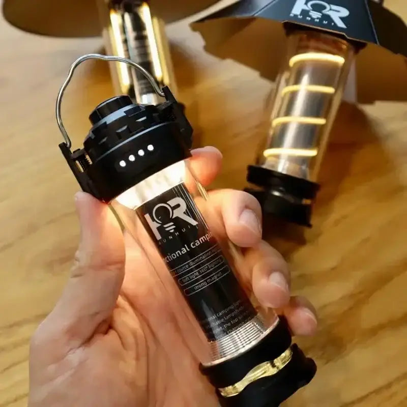 Handheld flashlight with a black and gold design.