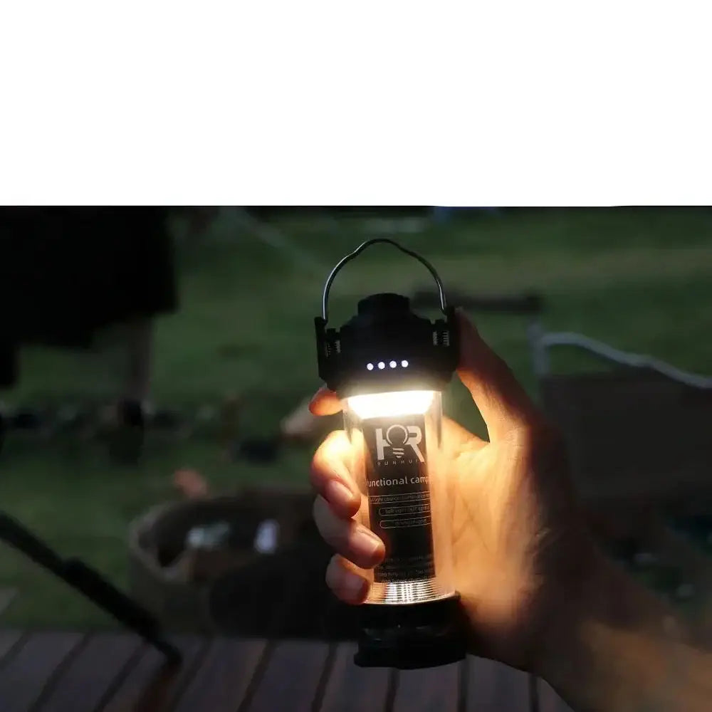 Glowing portable lantern held by a hand in low light conditions.