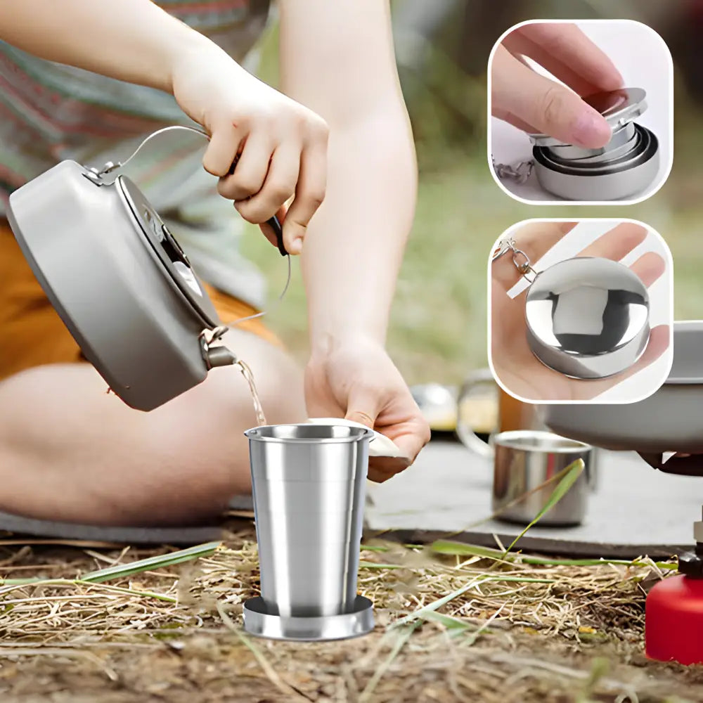 Portable camping stove or cooking set with a kettle pouring liquid into a metal cup.