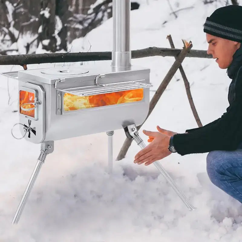 Portable outdoor stove with glowing interior visible through glass windows.