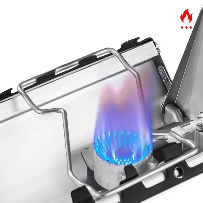 Portable camping stove with a blue flame burning.