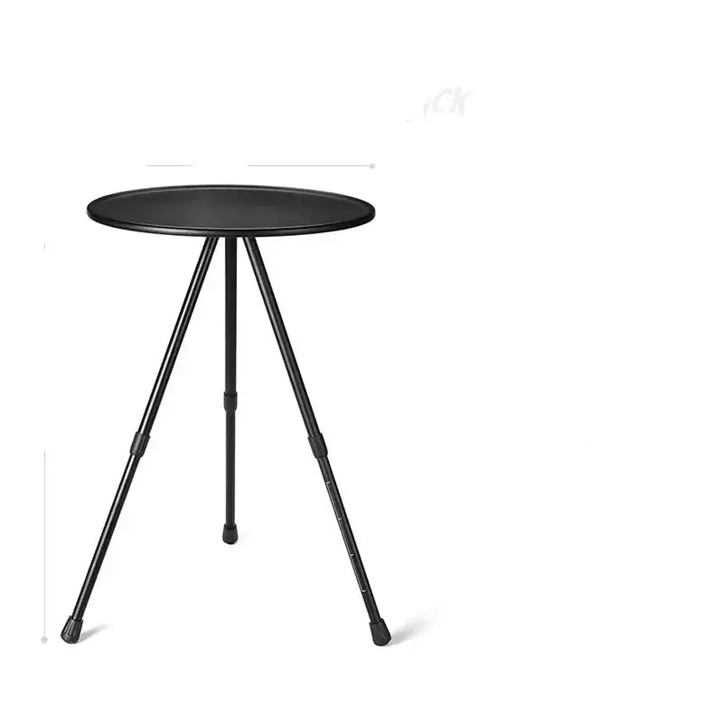 Round black side table with three thin metal legs.