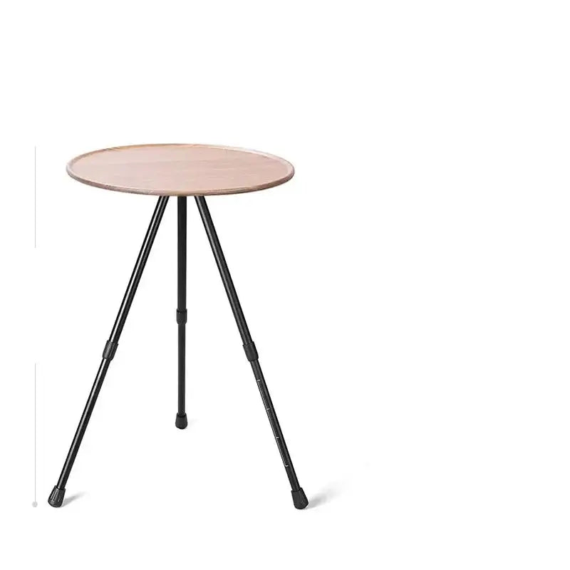 Round side table with a light-colored top and three thin black metal legs.