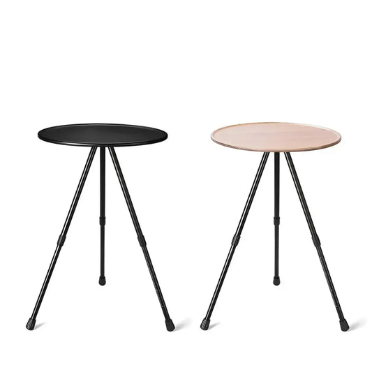 Two minimalist side tables with circular tops and tripod metal legs.