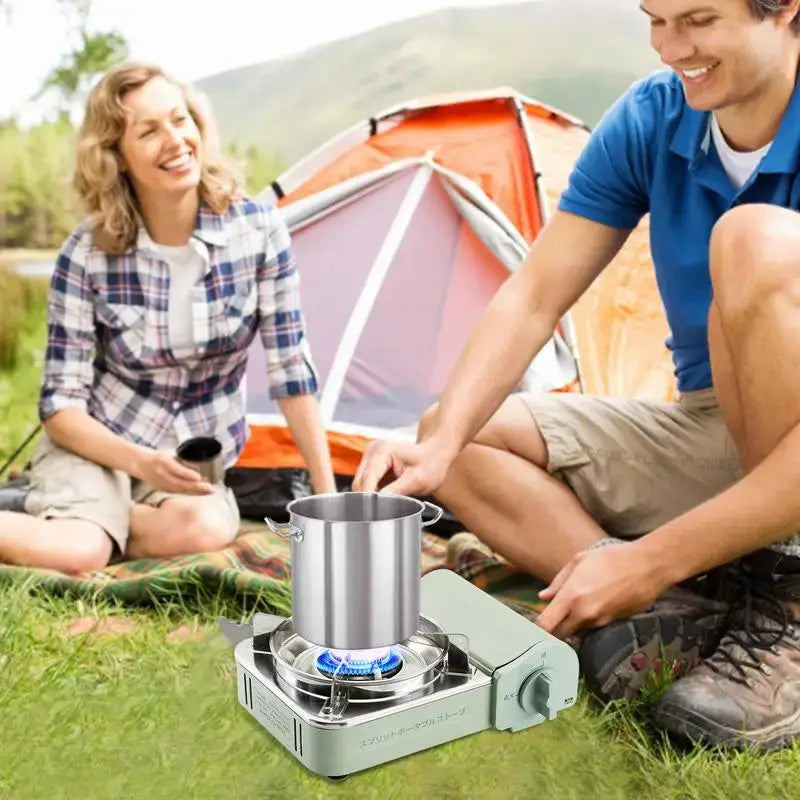 Portable camping stove with a metal pot on top.