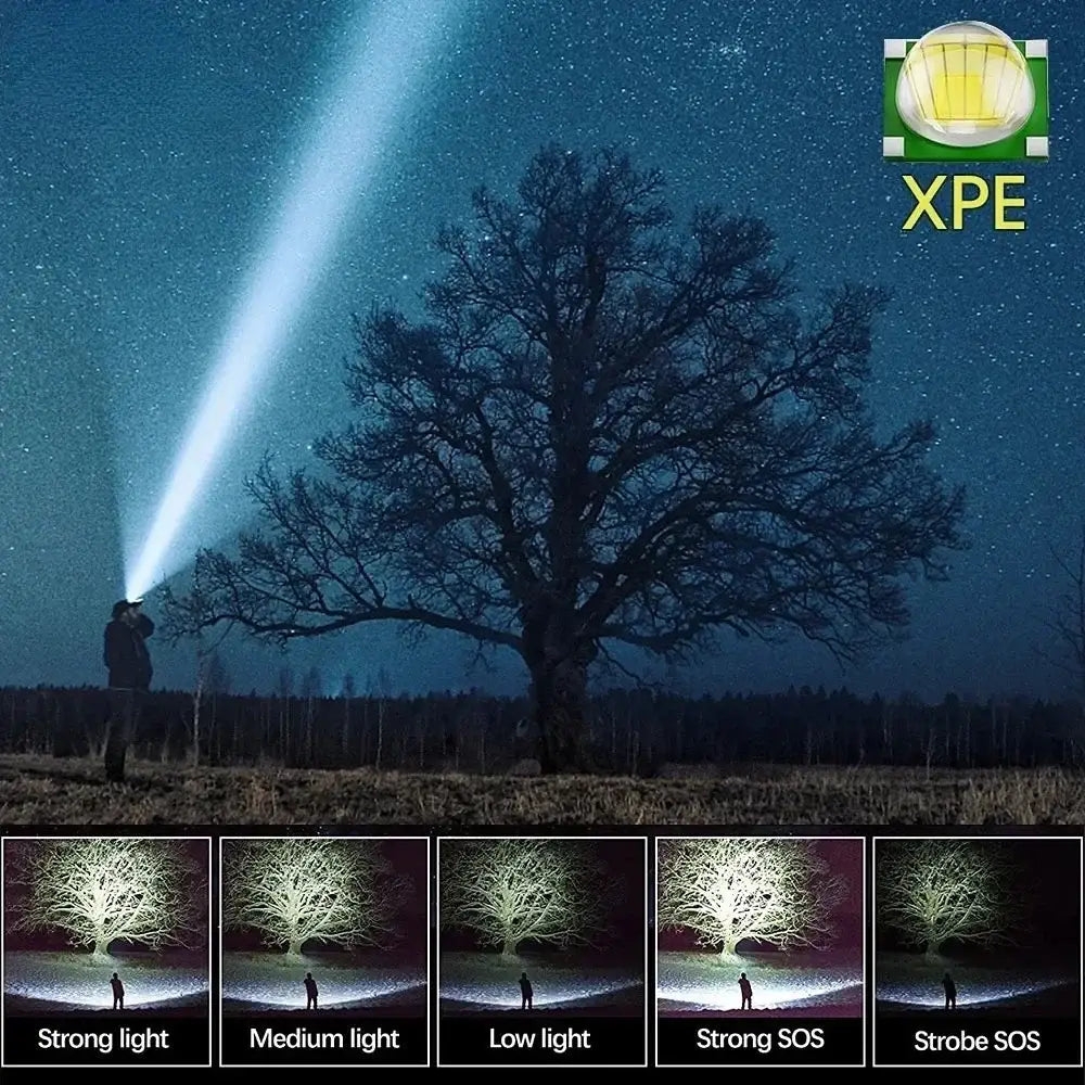 Flashlight with multiple light modes illuminating a tree at night.