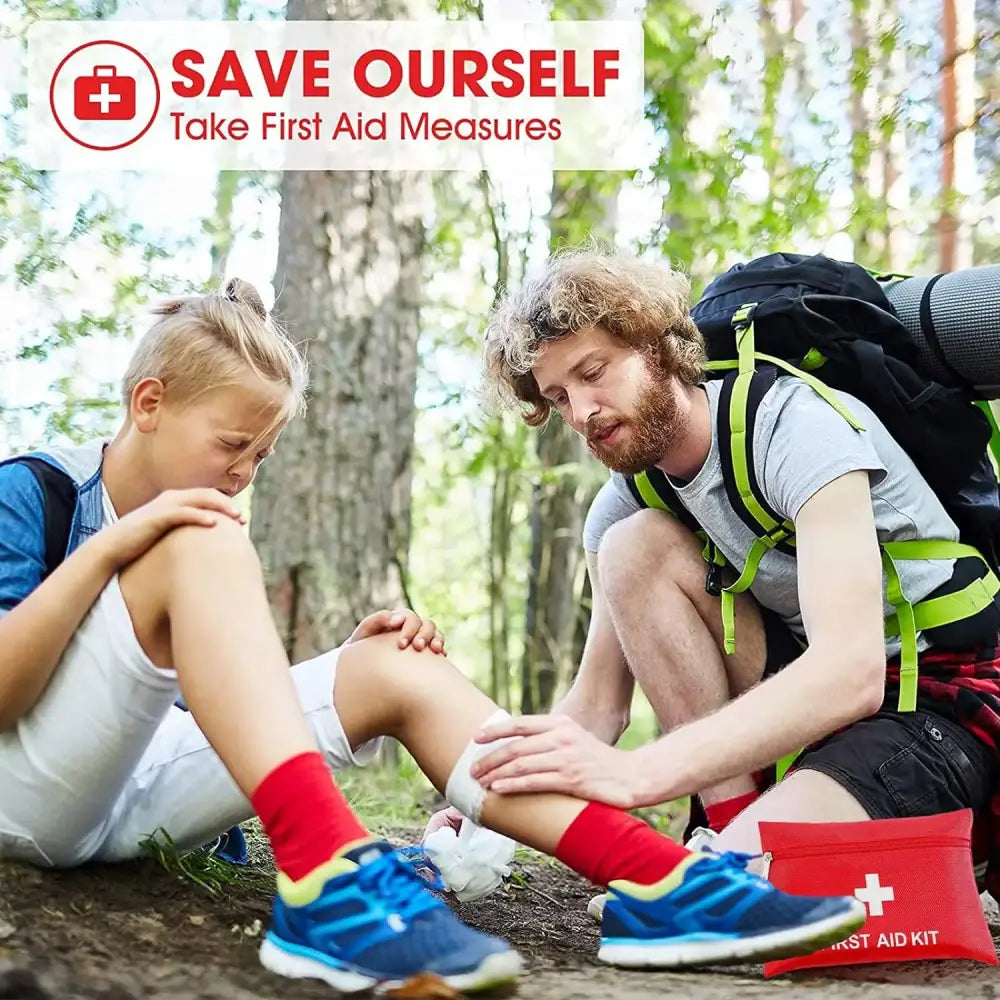 A man helping a child with a leg injury in a forest setting.