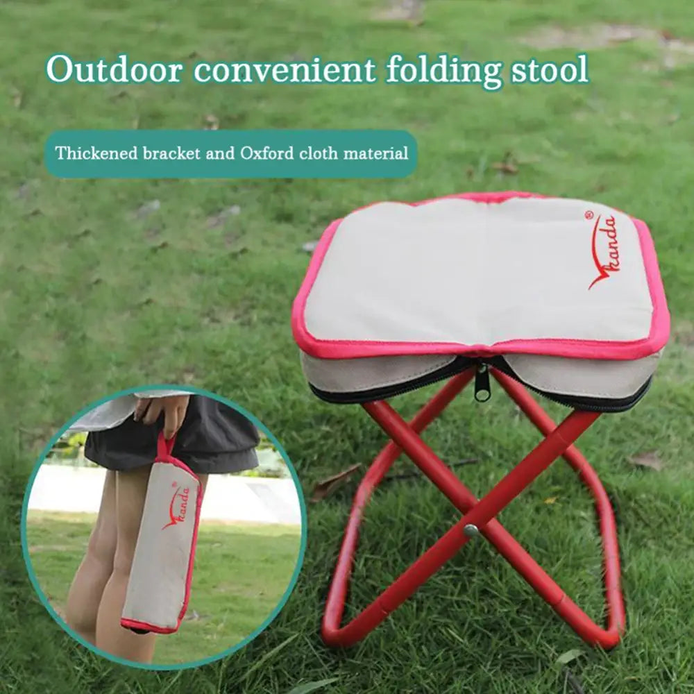 Portable folding stool with a white seat and red metal frame for outdoor use.