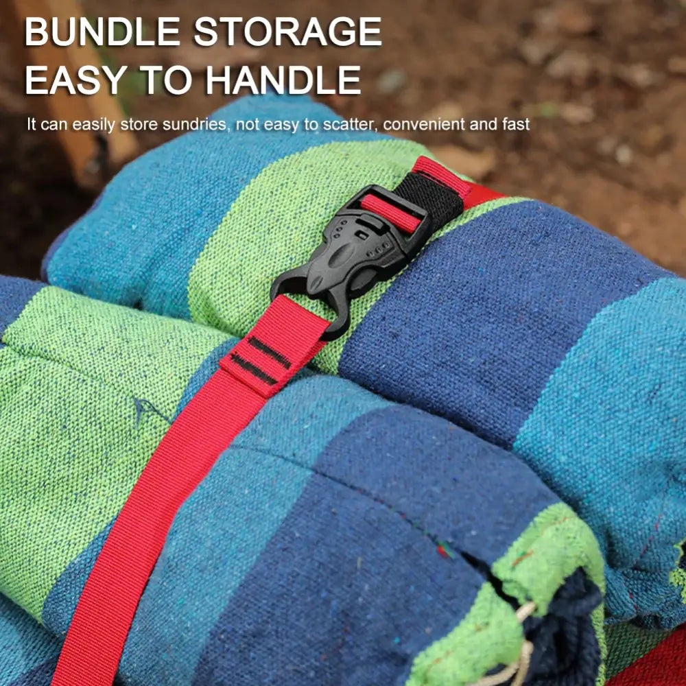 Rolled-up colorful towels or blankets secured with a red strap and buckle.