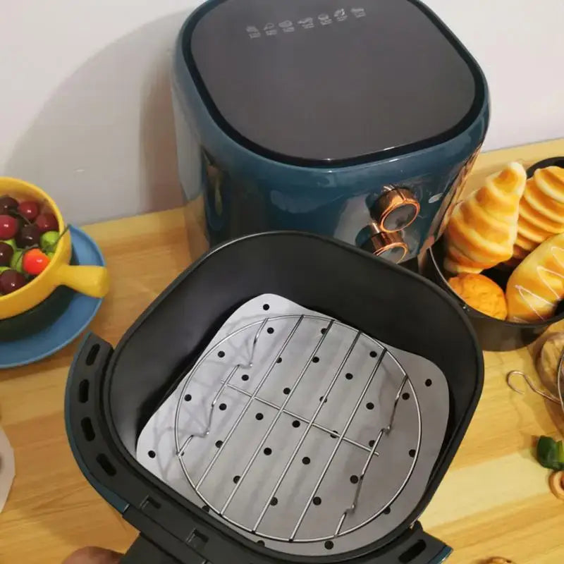 Air fryer with its basket open, revealing the cooking tray inside.