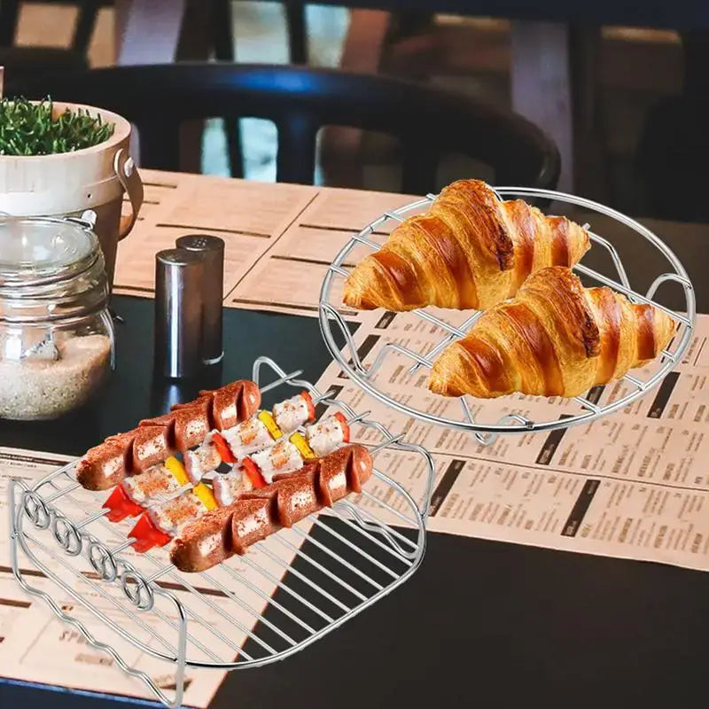 Wooden table set with croissants, appetizers, and a potted plant.