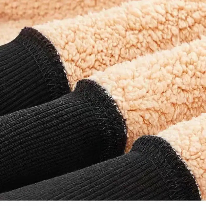 Black socks on a beige towel or carpet.