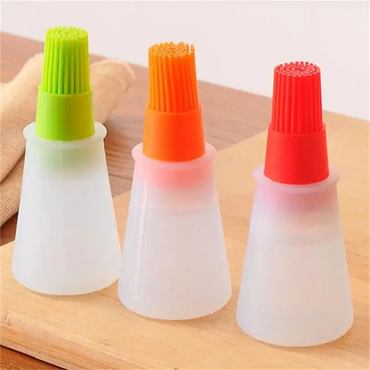 Set of three silicone basting brushes with colorful tops in green, orange, and red.