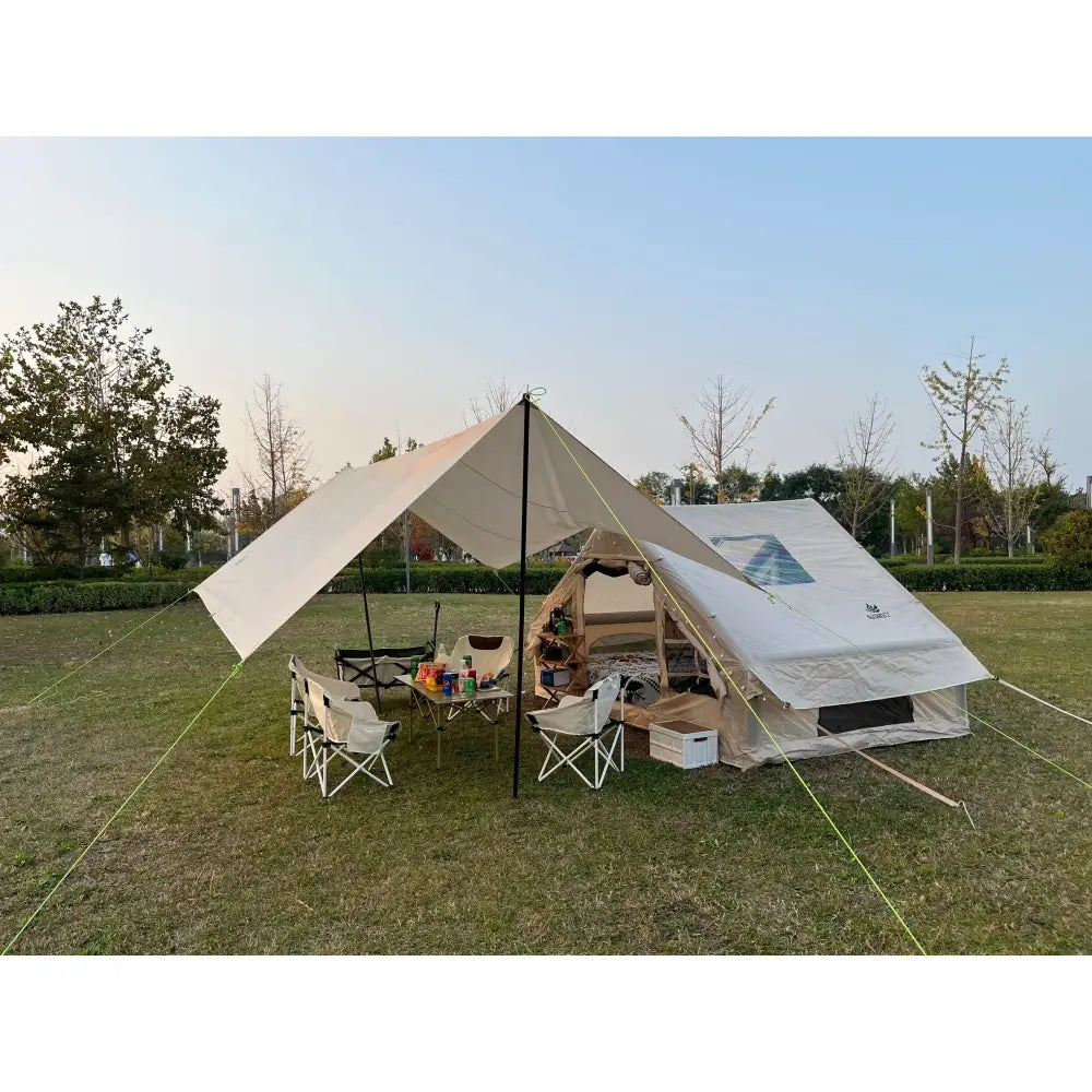 Camping setup with a canvas tent and canopy shelter.