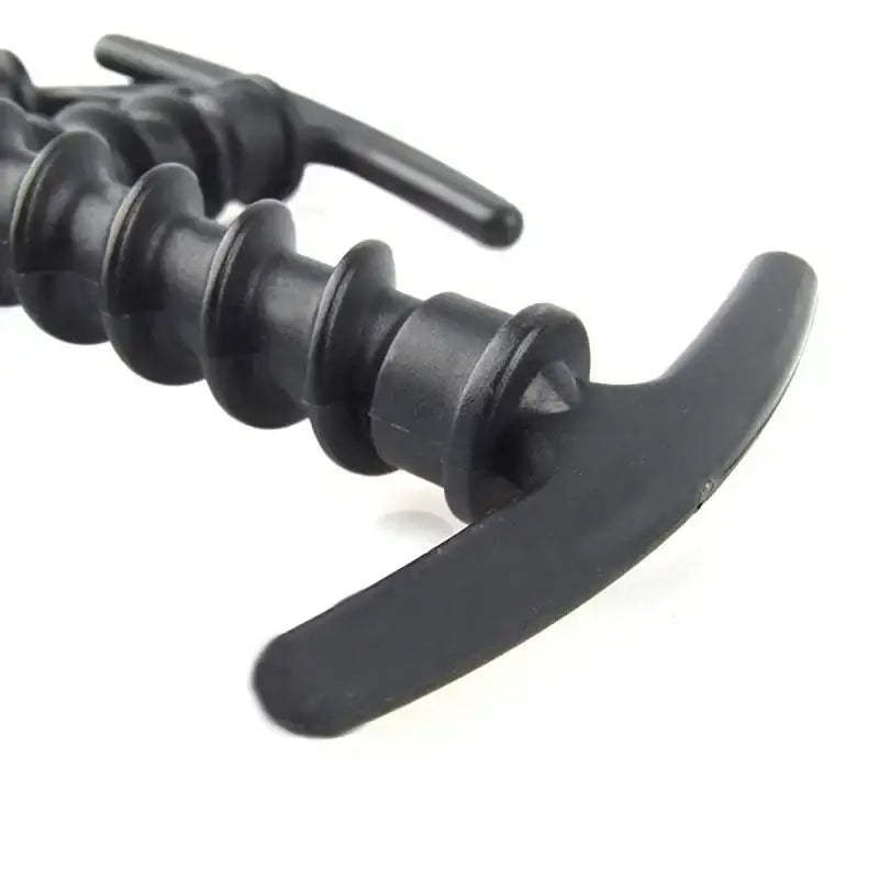 Black plastic corkscrew with a curved handle and spiral screw.