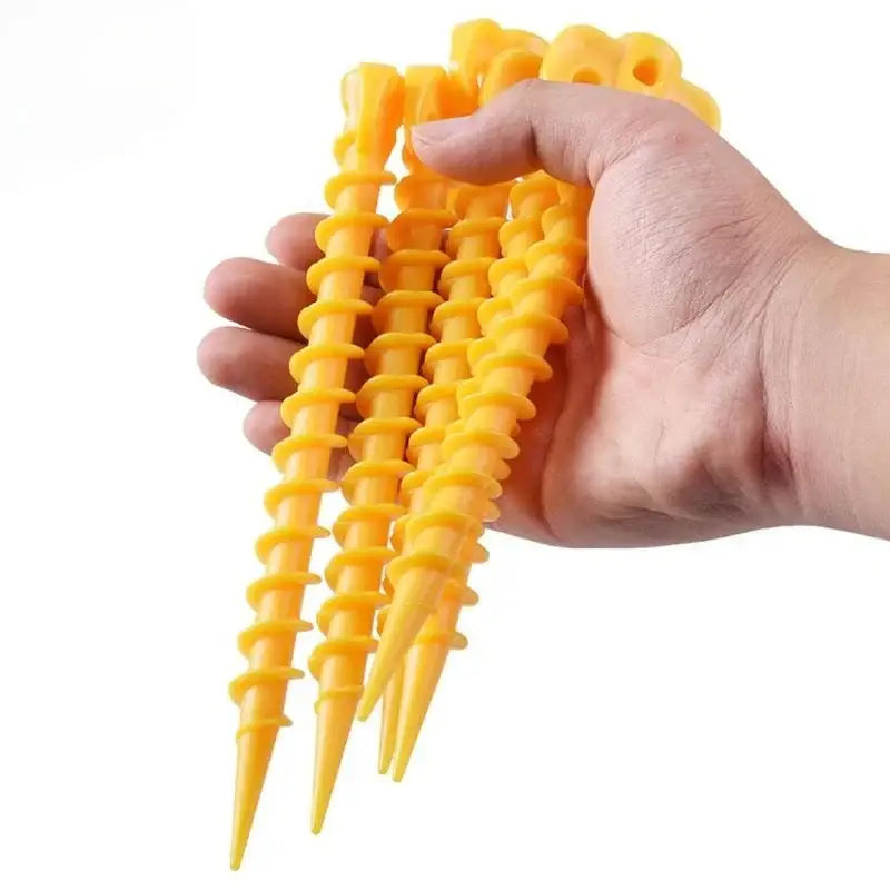 Spiral-cut french fries held in a hand.