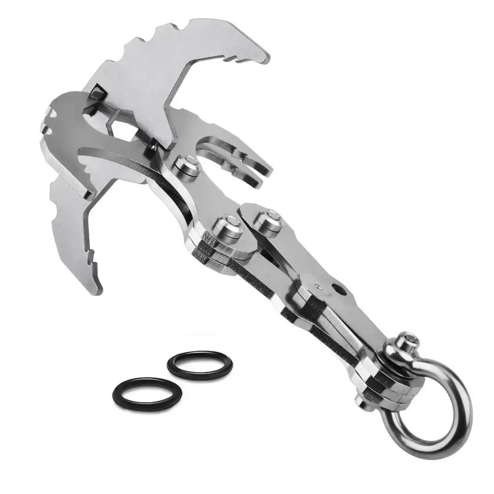 Metallic grappling hook or climbing tool with multiple prongs and a ring attachment.