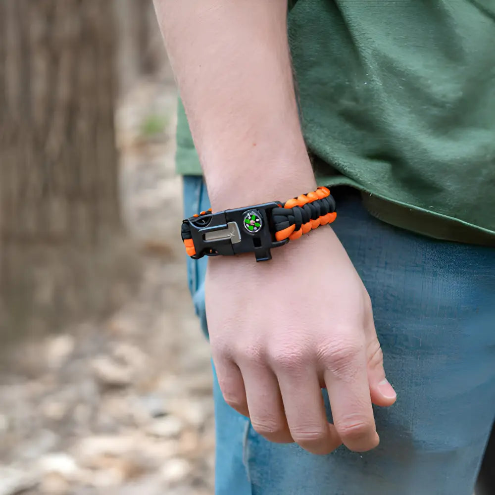 Paracord survival bracelet with a compass and plastic buckle clasp.