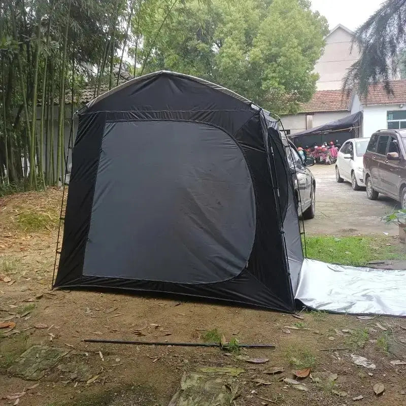 Black pop-up tent or shelter set up outdoors.