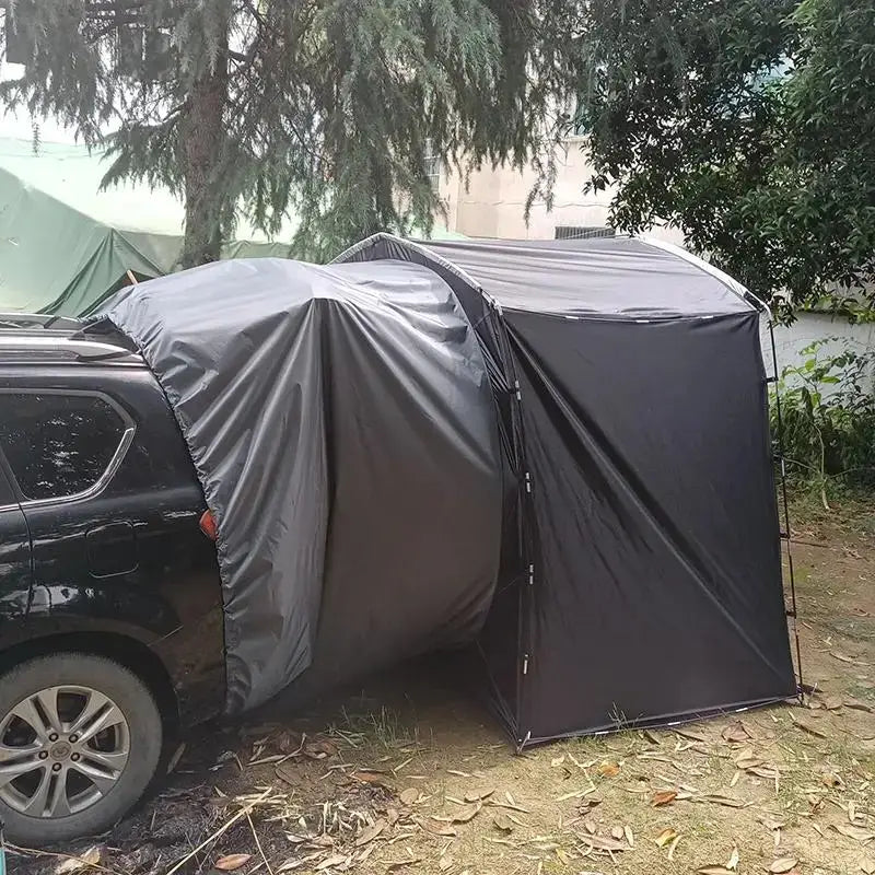 Car-attached tent or camping shelter connected to a vehicle’s rear.